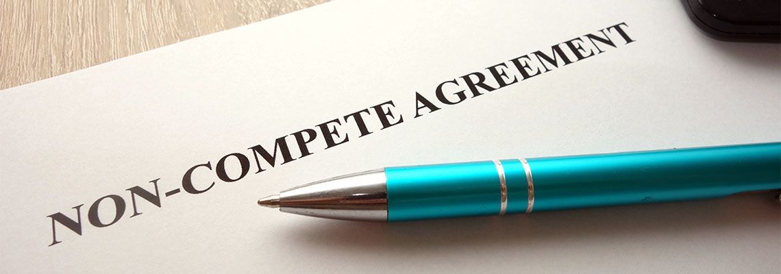 Non-Compete Agreement file and pen in table