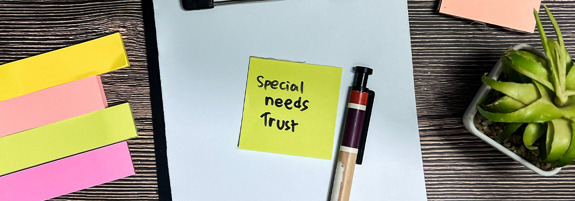 Concept of Special Needs Trust write on sticky notes isolated on Wooden Table