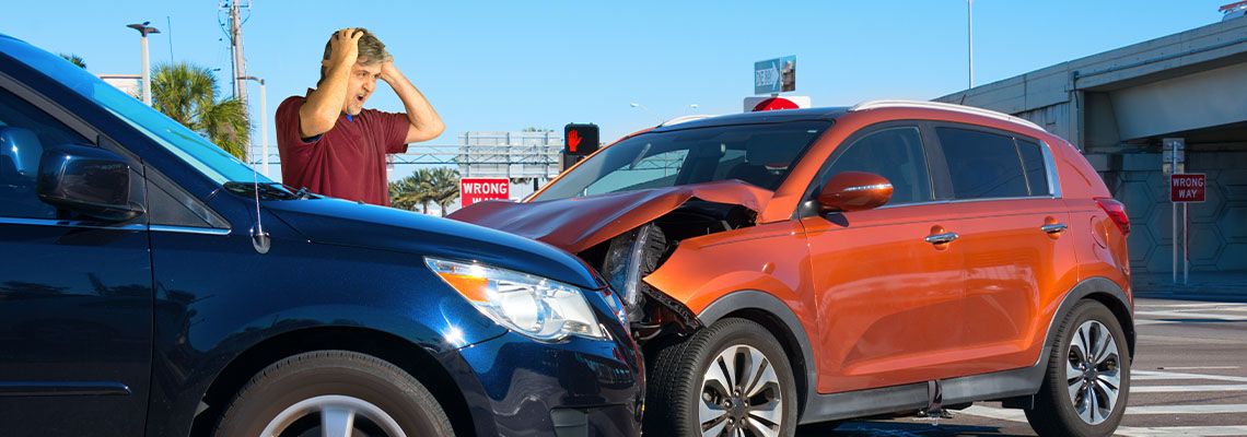 Worried man after car accident at intersection