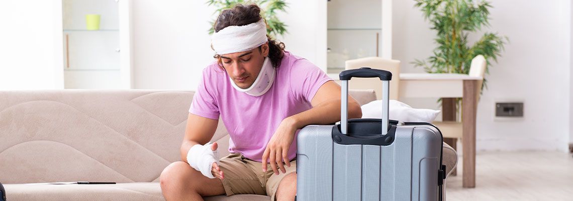 Injured man with suitcase