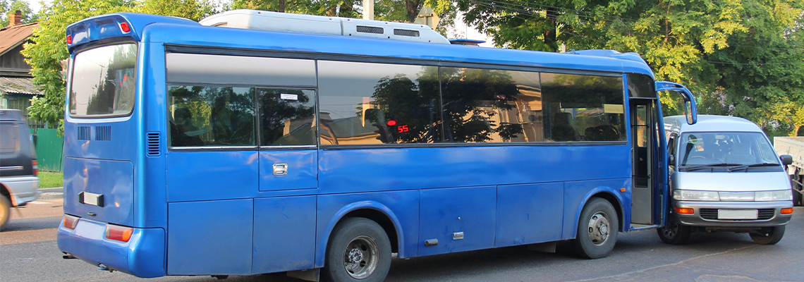 Bus and car collision on street