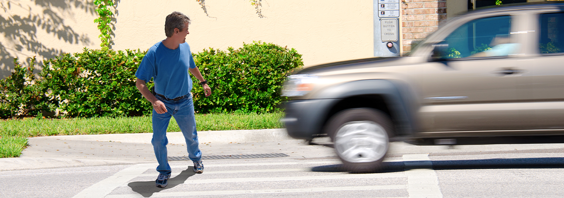 A man is jaywalking across an intersection