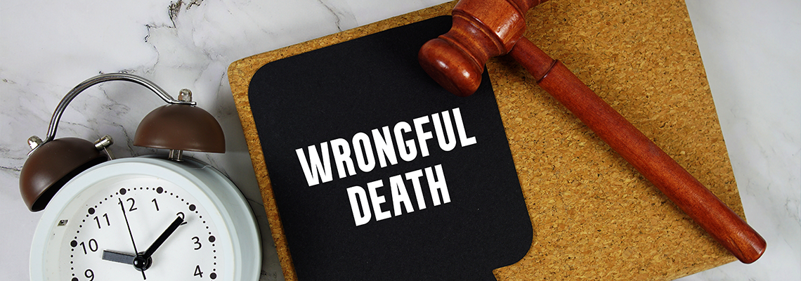 Wrongful Death text on speech bubble with alarm clock and wooden gavel