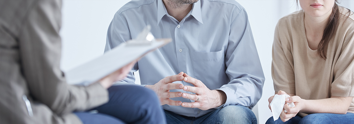 Couple considering a divorce sitting down with lawyer