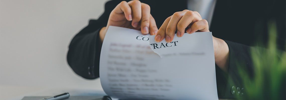 Women tearing contract paper