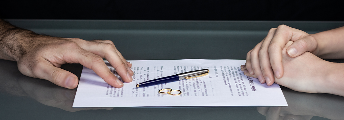Couple goes through divorce signing papers