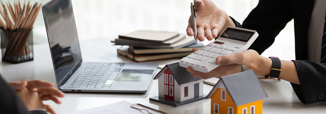 Businessman, real estate agent holding a calculator, presenting a price quote