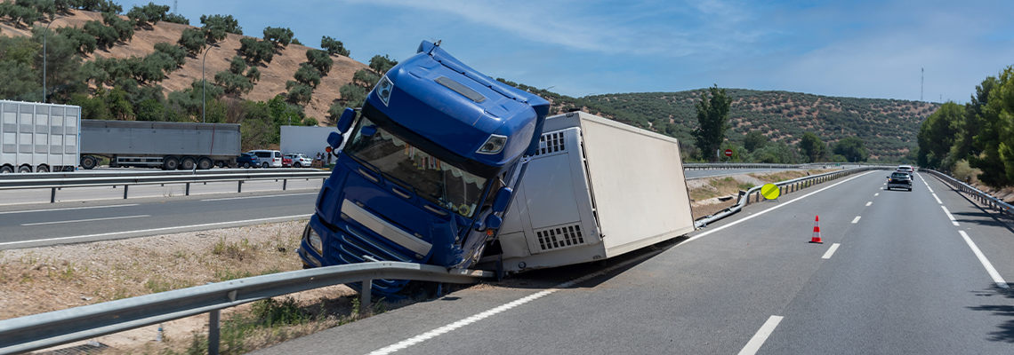 Truck with an accident refrigerated semi-trailer, overturned by the exit of the highway