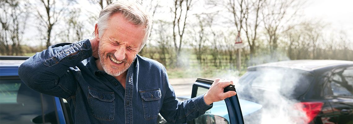 Man suffering from whiplash injury after car accident