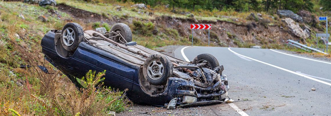 Overturned car lies on the roof