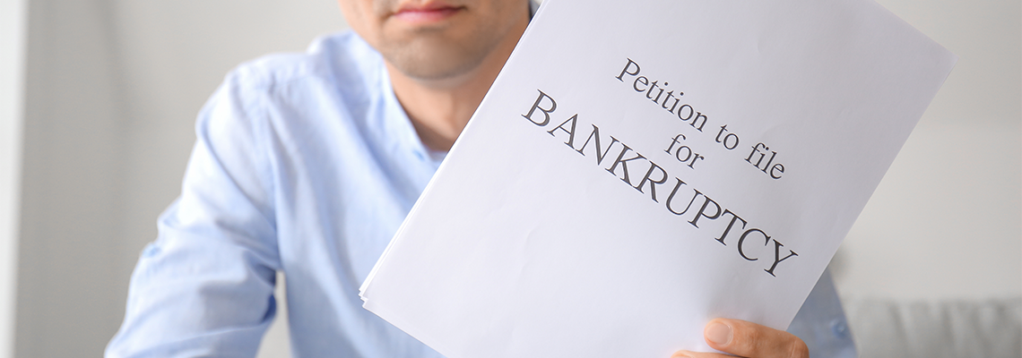 Stressed Man with Petition to File for Bankruptcy at Home