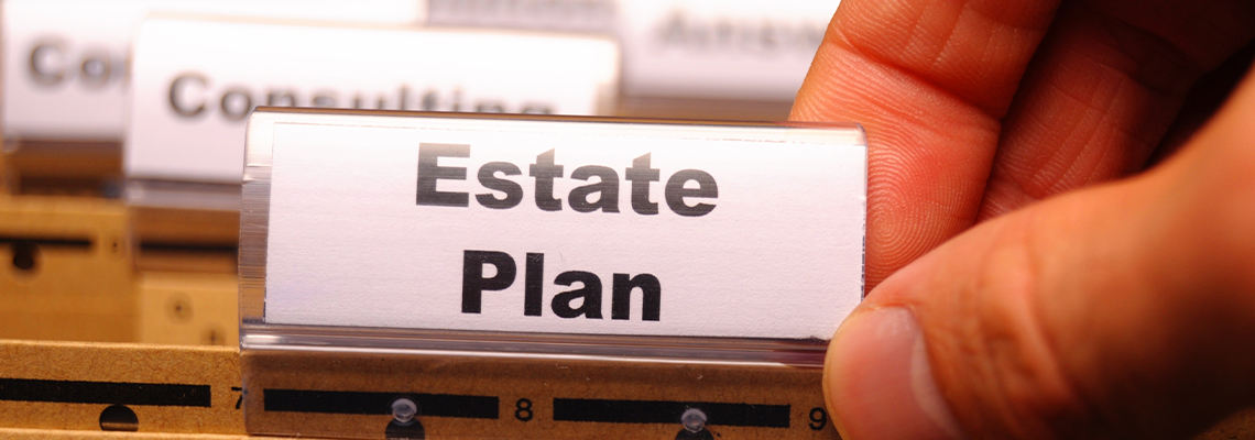 Man Holding Paper with Text "estate Plan"