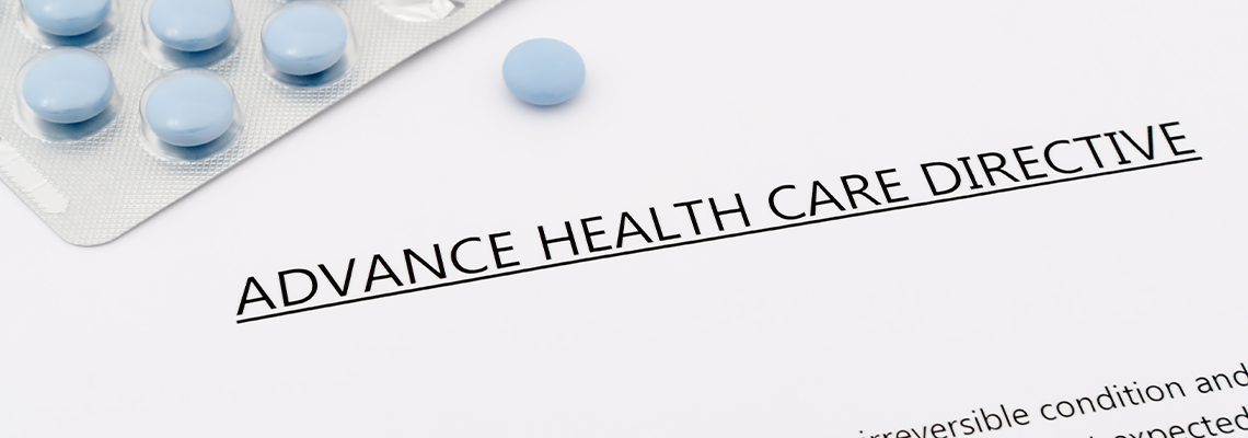 Advance health care directive with blue pills and grey pen