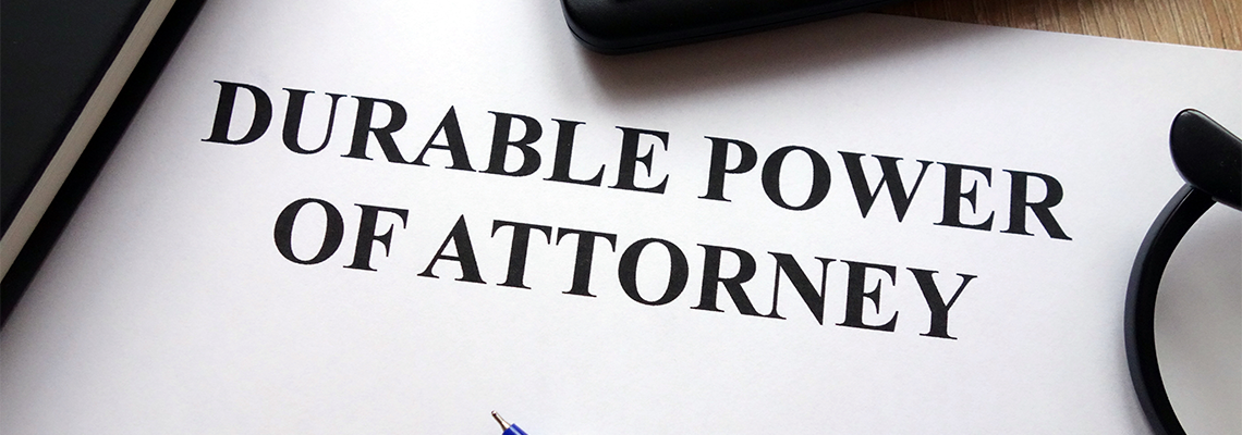 Durable power of attorney document, pen, glasses and calculator on desk