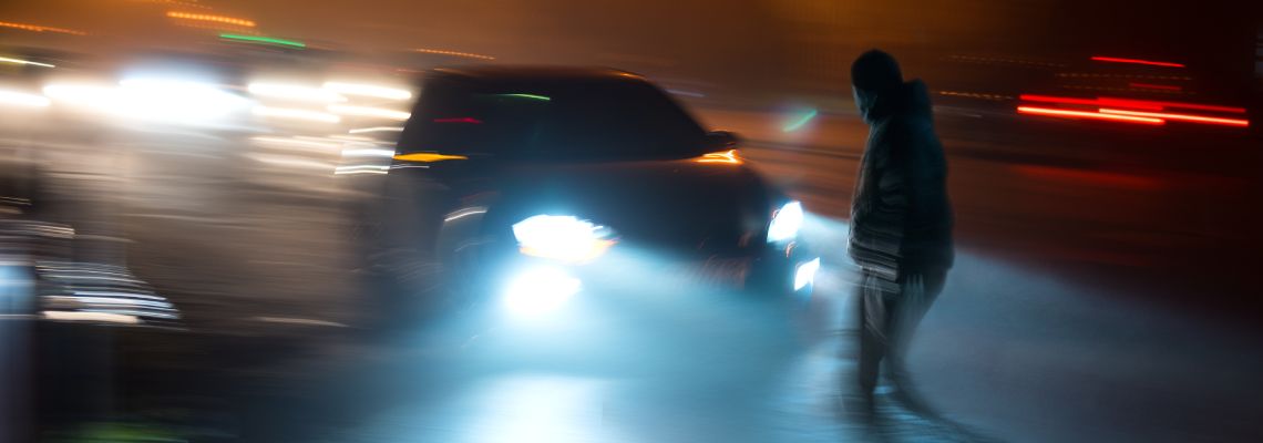Car about to collide with pedestrian in road
