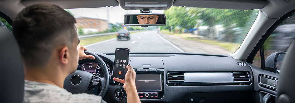 Businessman talking on cell phone while driving