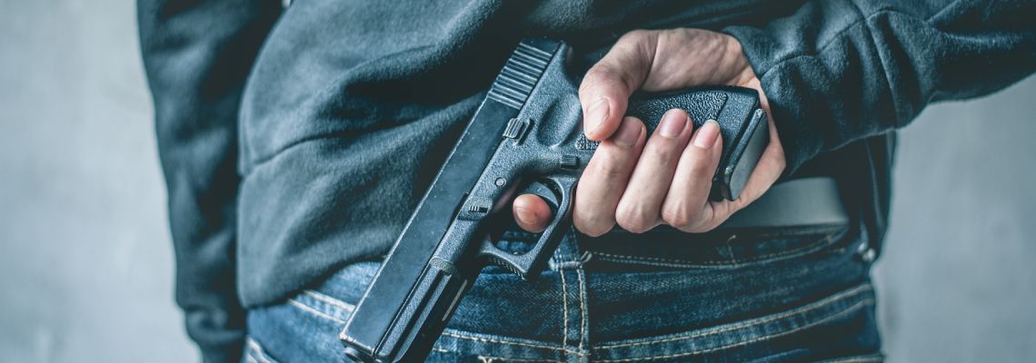 Man holding gun on his back