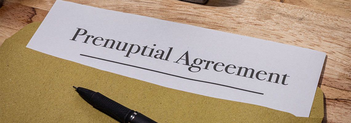 Prenuptial Agreement file and pen in table