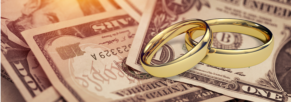 Wedding Rings on Top of Dollar Cash