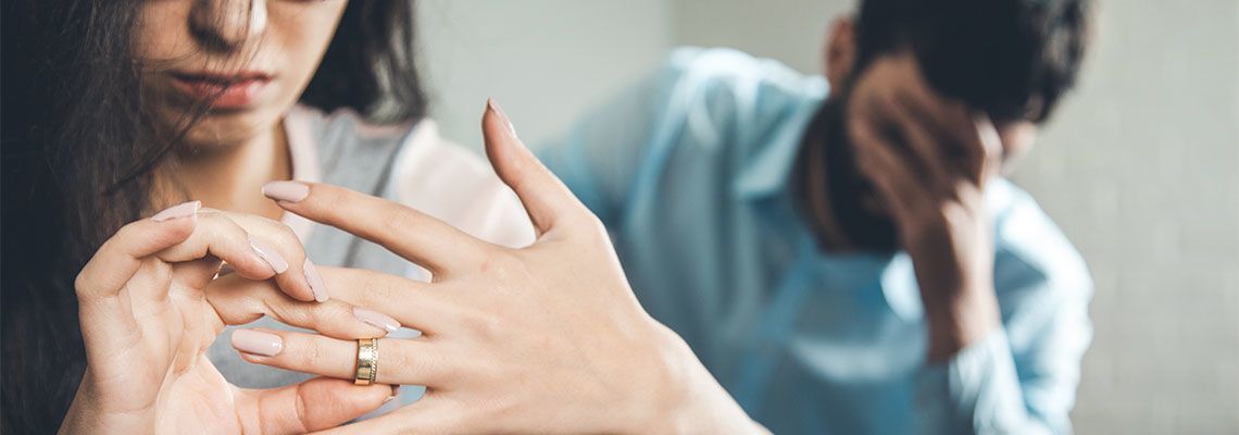 Women removing wedding ring from finger