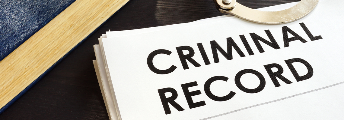 Criminal Record and Handcuffs on A Desk