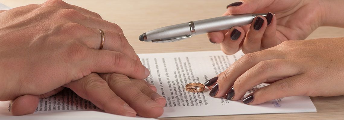 Wife and husband signing divorce documents