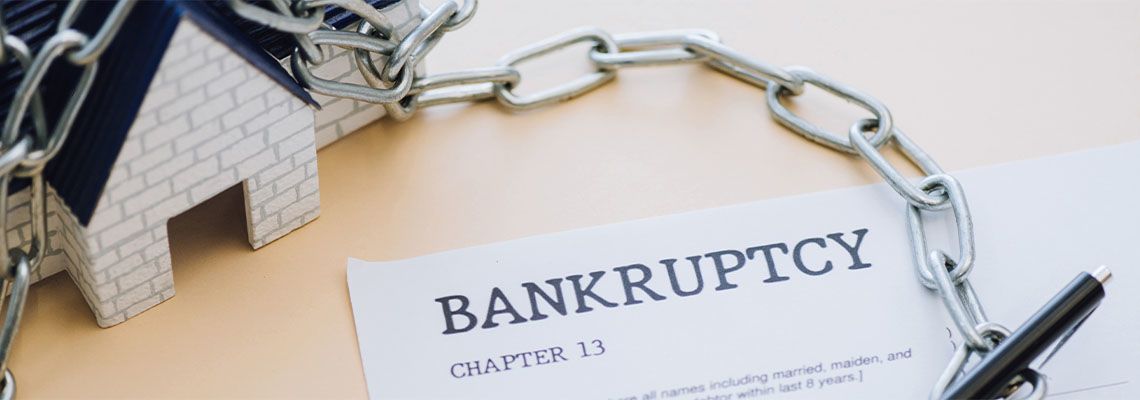 Document with bankruptcy chapter 13 lettering near house model
