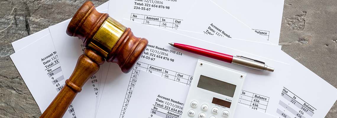 Judge hammer near financial documents on grey background top view