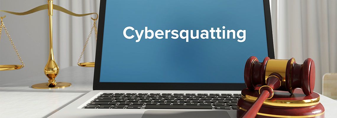 Cybersquatting term on laptop screen along with gavel on table