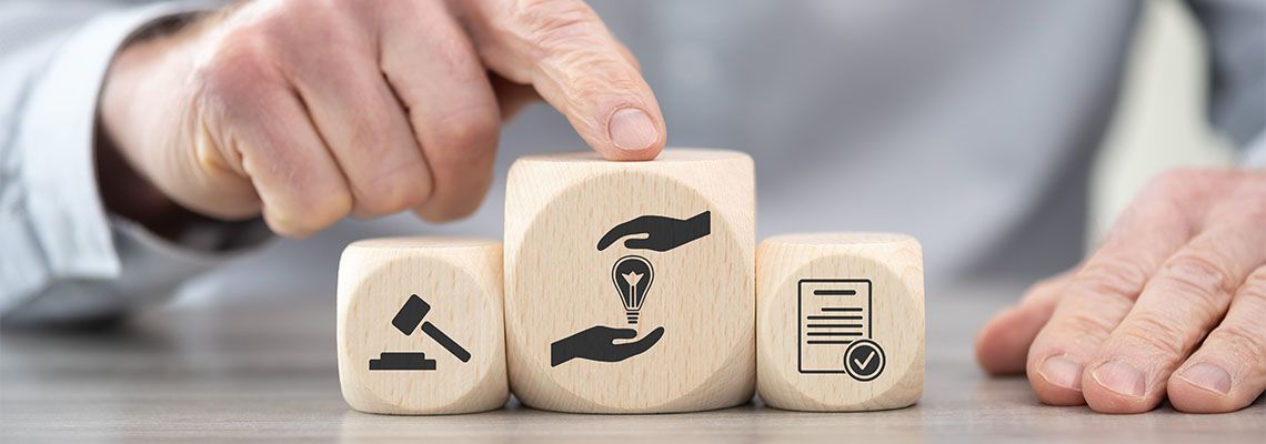 Wooden block with icons related to patent