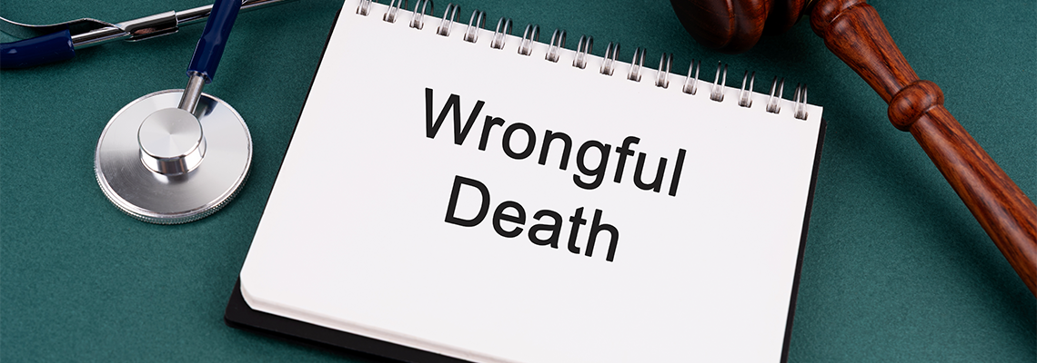 High angle view of Gavel and Wrongful Death text on a Notebook