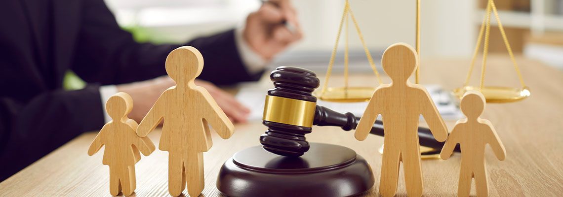 Family figures with gavel and scale of justice
