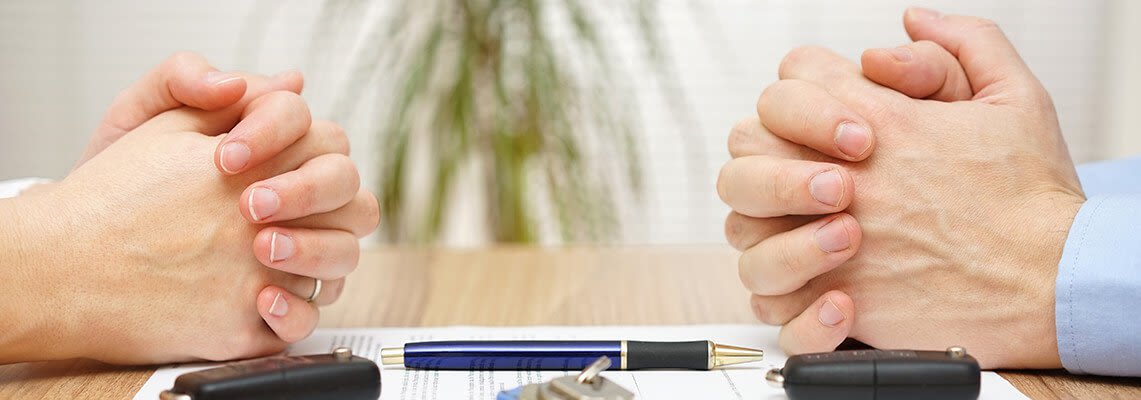 Couple sitting at a table to sign documents