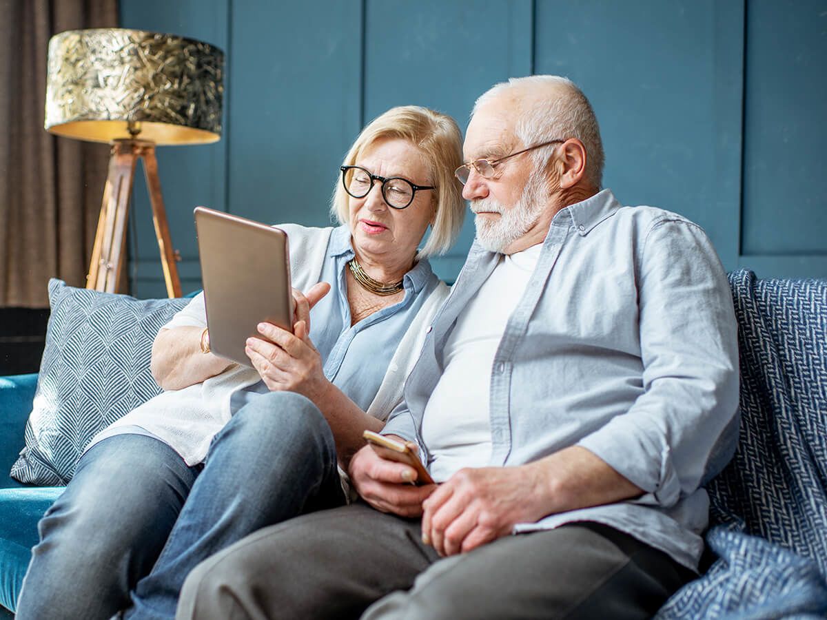 Elderly couple looking at tablet