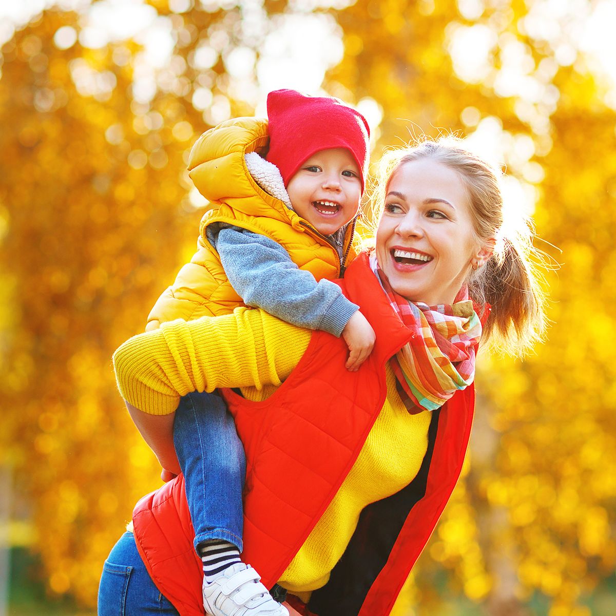 happy mother and baby son on autumn walk