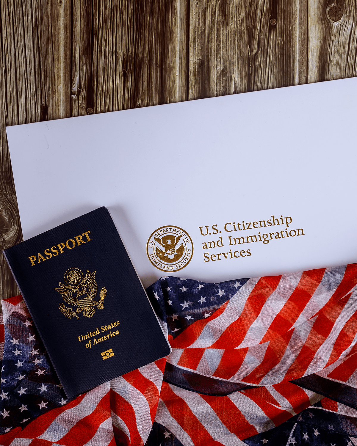 USA passport and naturalization certificate of citizenship US flag over wooden background