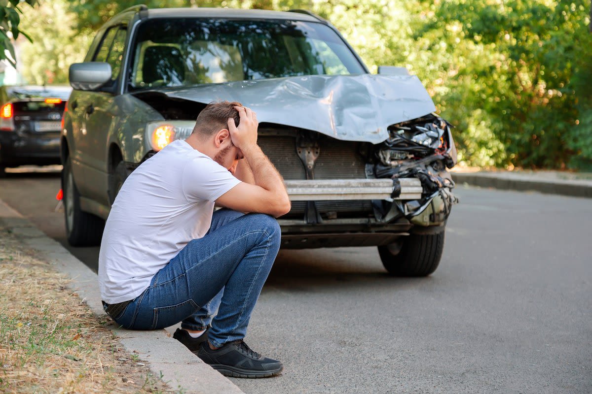 Car accident man holding his head