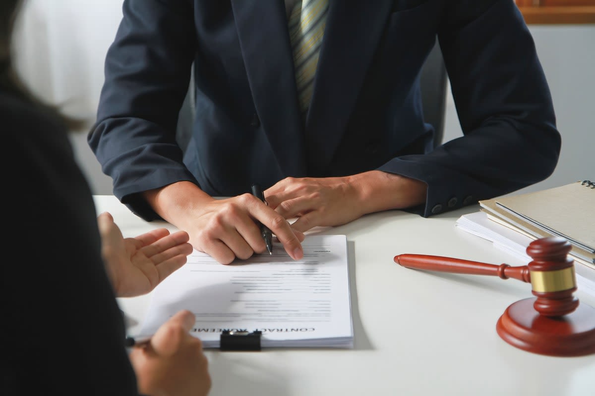 Men signing paperwork