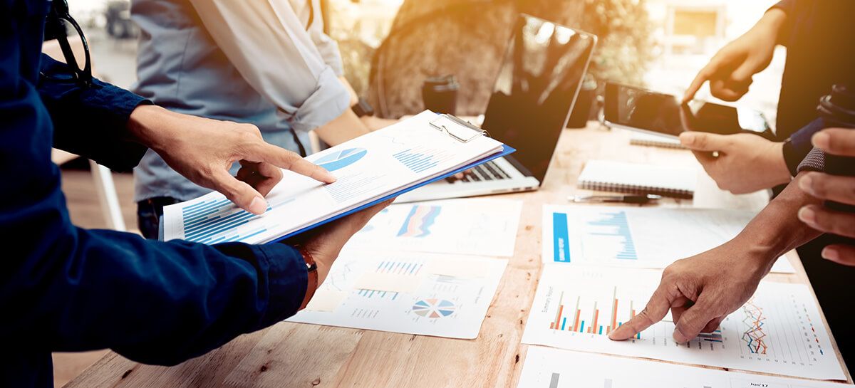 Group of people reviewing data and financial documents