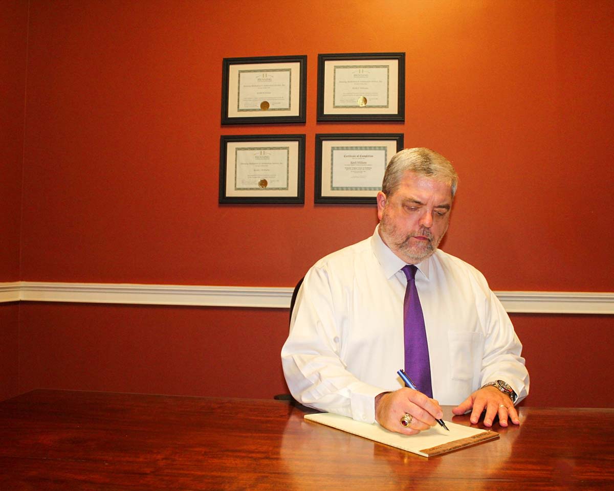 Attorney Keith J. Williams writing on a pamphlet
