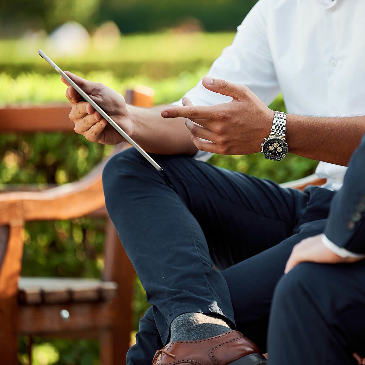 Businessmen meeting on park bench