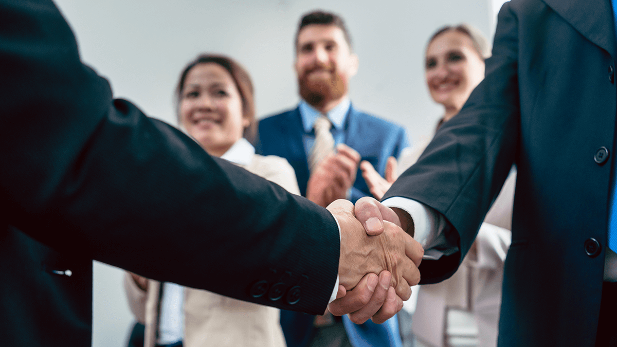 attorneys shaking hands in front of people