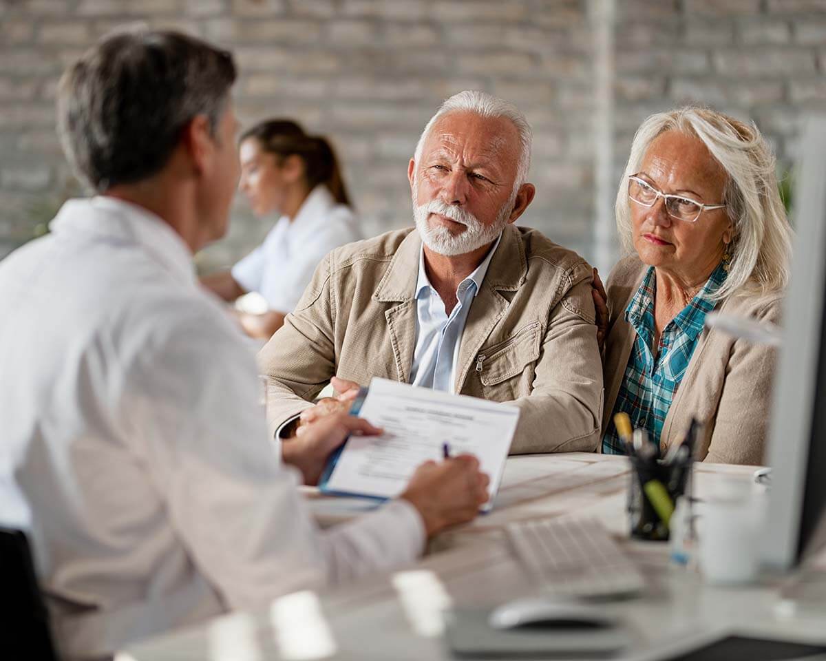 An attorney walking his elderly clients through a document