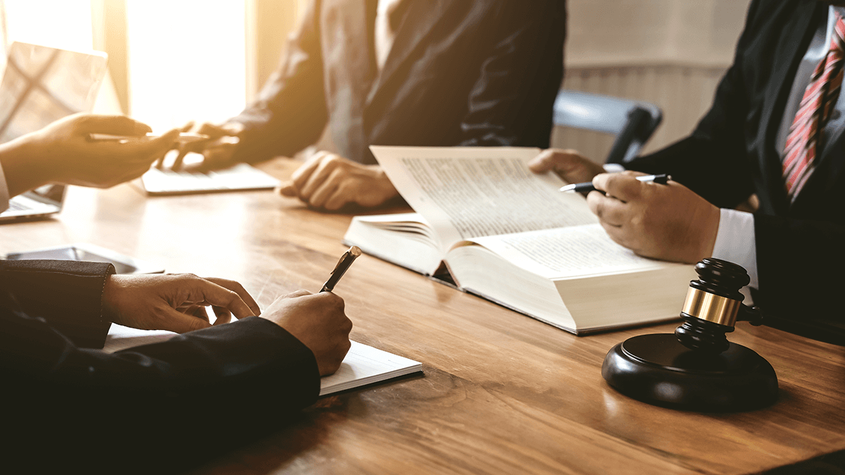 Two attorneys working with clients on a case.