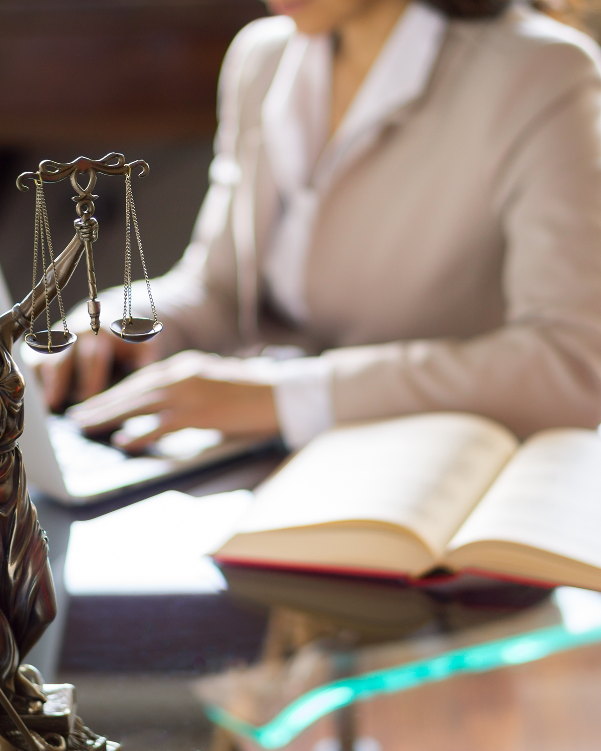 A woman attorney typing at her desk.