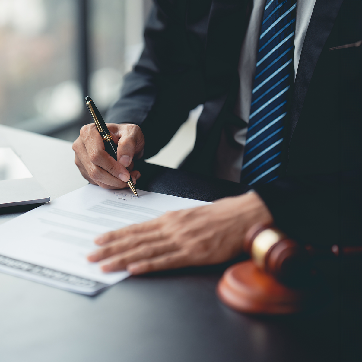 An attorney signing a document.