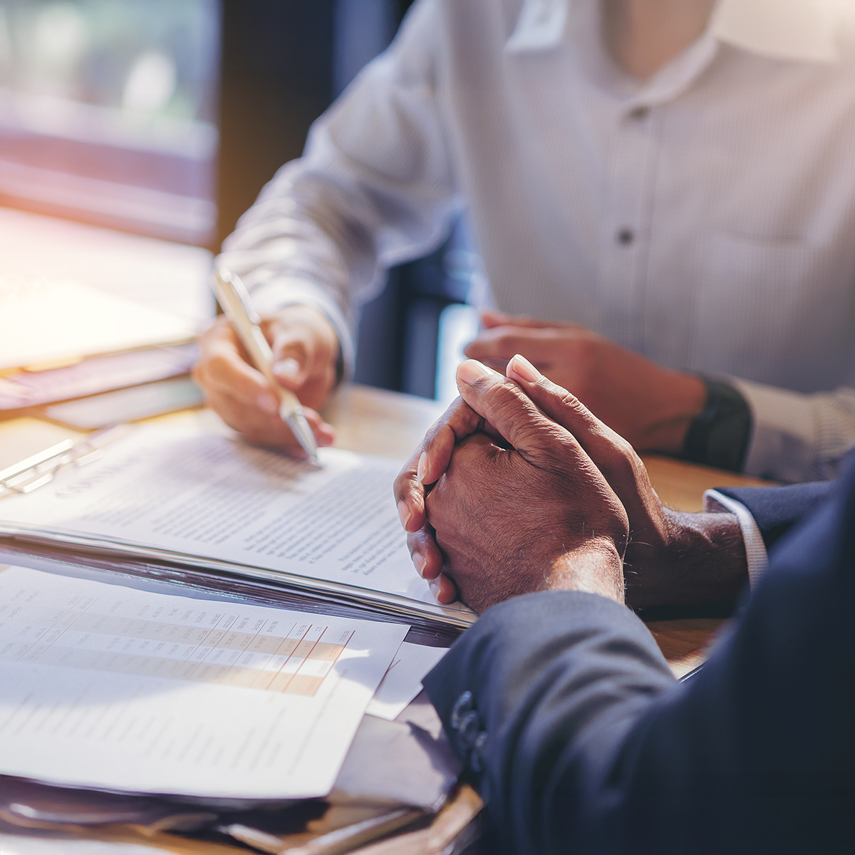 Two professionals gathered around going over paperwork