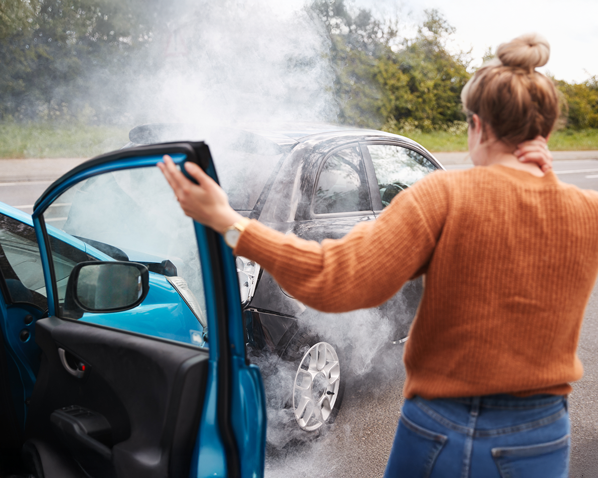 A woman holding her neck after getting involved in a car wreck.