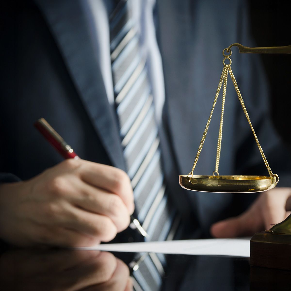 An attorney writing at his desk