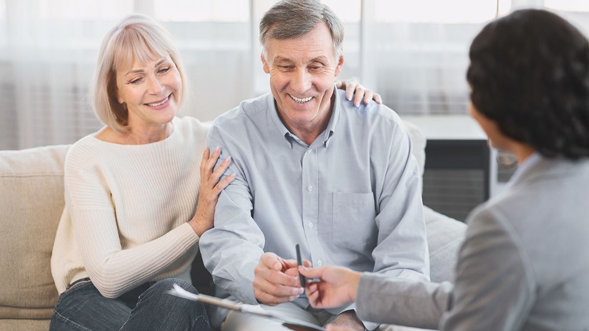 An older couple signing estate planning documents